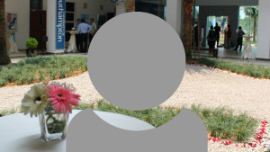 A grey person icon showing just head and shoulders with an interior of a University of Malaysia building background.