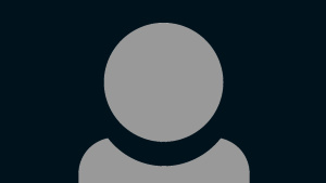 A grey person icon showing just head and shoulders with a very dark blue background.